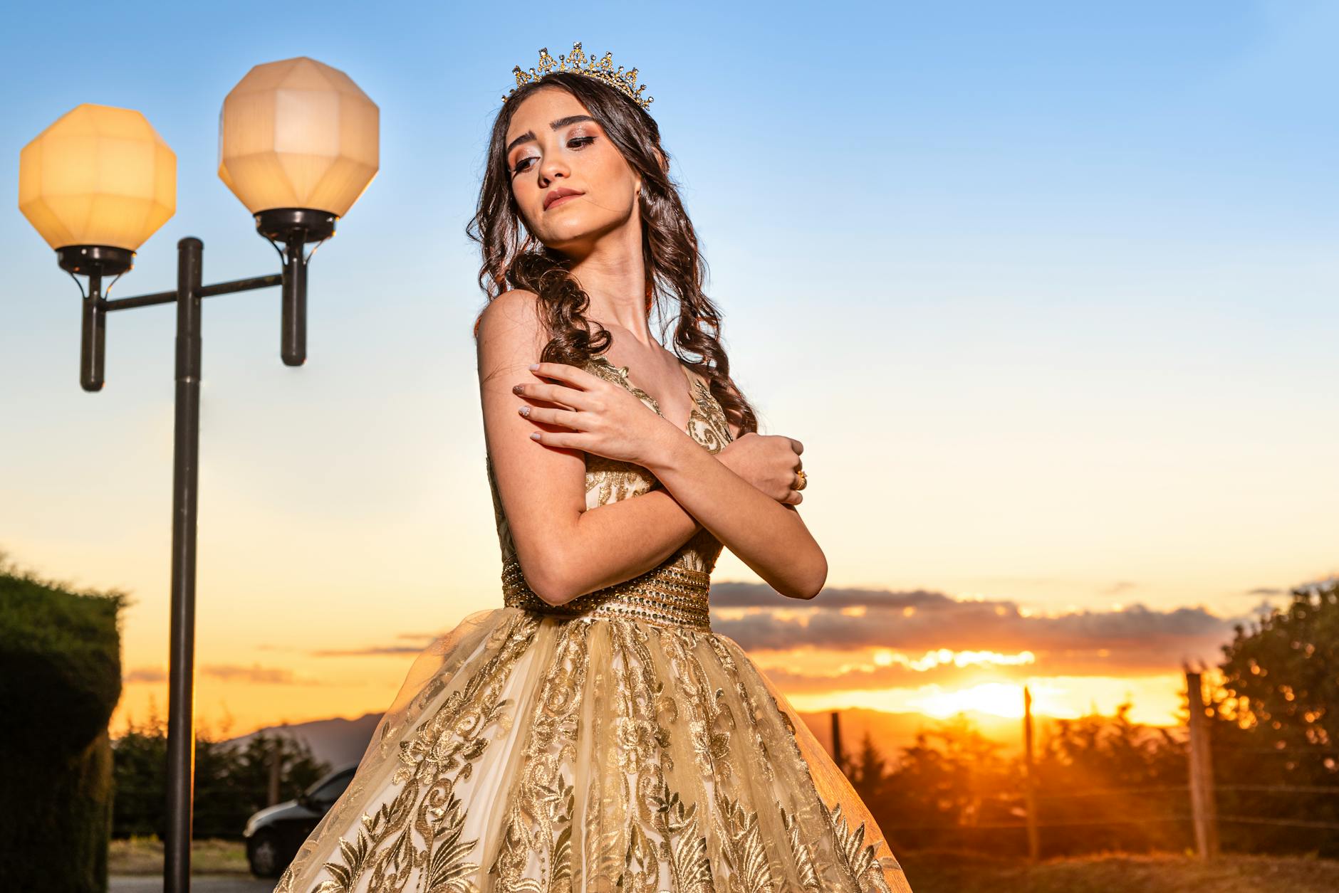 Woman Posing in Golden Dress at Sunset