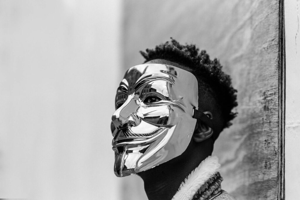 Black activist wearing Anonymous mask as sign of protest